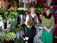 Sue, Reno and Vita with flower display