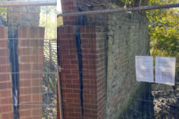 Owner of Dangerous Riverside Wall Remains a Mystery