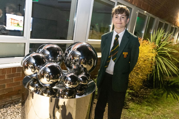 Jamie Perotti with the St Benedict's 120th Anniversary sculpture. Picture: St Benedict's School 