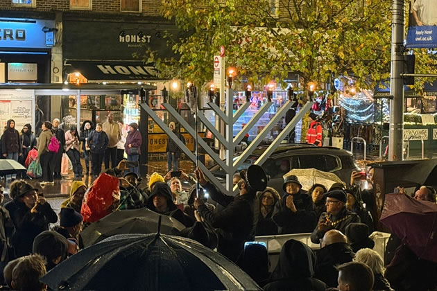 Police officer Muhammed Dar lights a Chanukah candle