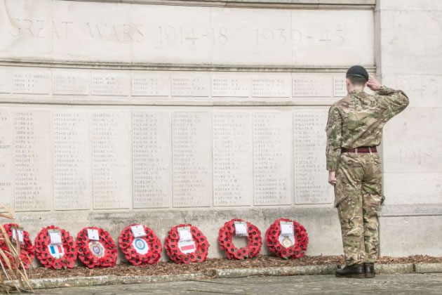 A soldier salutes at the Ealing War Memorial