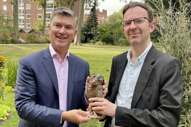 Christopher A. Marinello hands the recovered item to Dr. Jonathan Oates