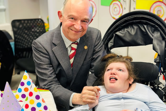 Richard Kornicki meets one of the school's pupils during his visit