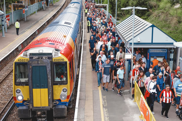 Brentford fans travelling to a match by train 