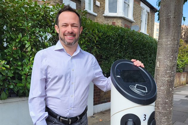 Cllr Gary Malcolm by an EV charging point 