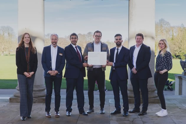 Salman Shaheen, Peter Mason and Mete Coban holding the signed agreement to deliver the regional park outside. with other leaders