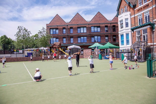 Children social distancing in the playground at St Benedict's school 