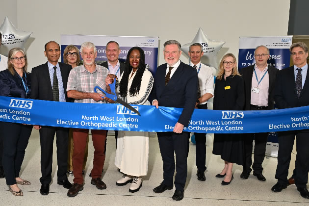 Centre's first patient David Wootton (holding scissors) does the honours 